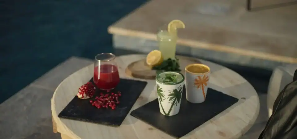 Colorful cocktails served on a rustic round table at Marrakech Stay Vip, perfect for enjoying Moroccan nightlife and relaxing with friends or loved ones.