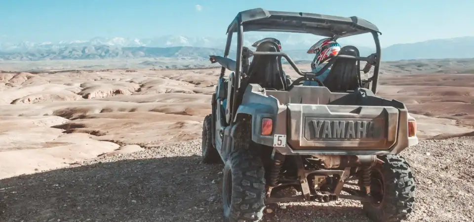 Off-road ATV adventure in the desert near Marrakech, Morocco with stunning mountain views in the background. Perfect for thrill-seekers and outdoor enthusiasts.
