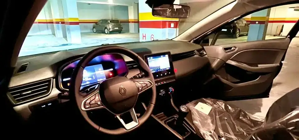 Luxurious modern car interior with advanced dashboard and touchscreen display, parked in a covered garage. Perfect for VIP Marrakech stays, blending comfort and style for a premium travel experience.